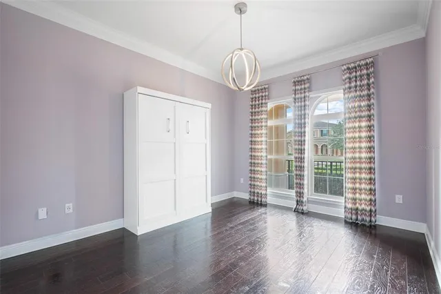 a room with a bed and a chandelier