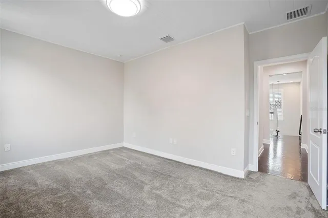 a view of walk in closet with empty racks