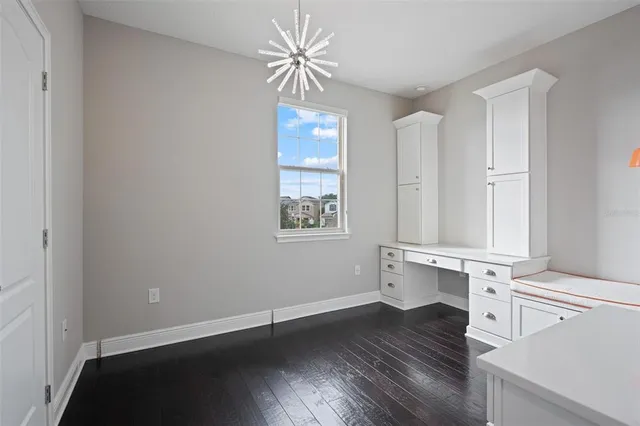 a spacious bedroom with a bed and a table in it