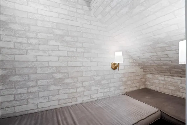 a room with pool table and windows