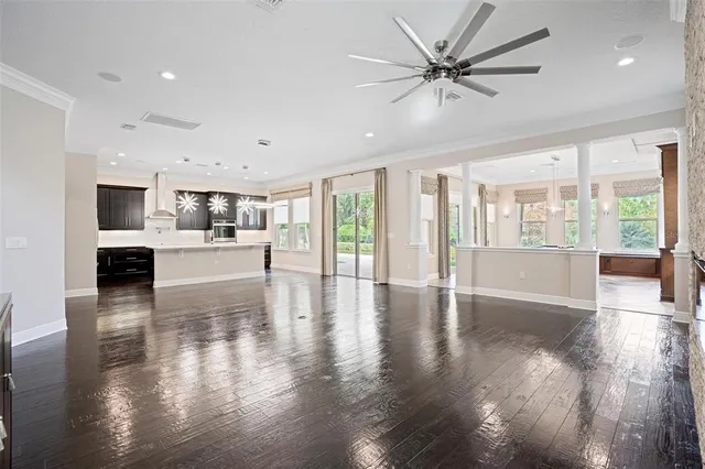 a room with pool table and windows
