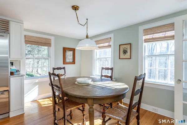 a view of a dining room with furniture window and wooden floor