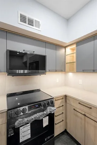 a kitchen with a stove microwave and sink