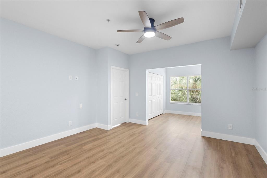 822 Camargo Way, Unit 307 Altamonte Springs, FL 32714 - Photo 23 of 46 an empty room with wooden floor and windows