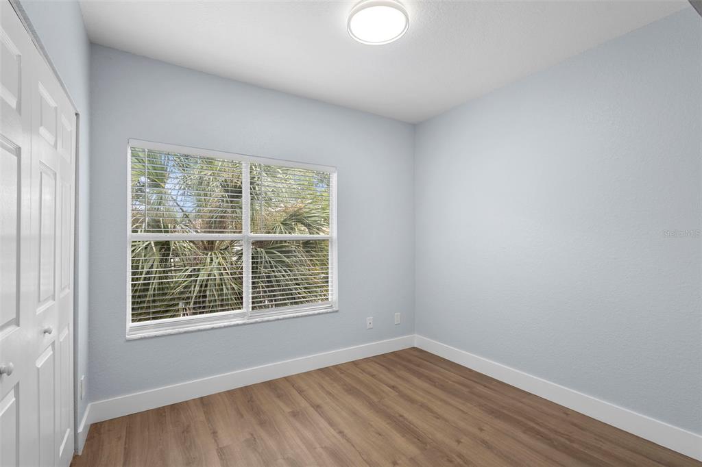 822 Camargo Way, Unit 307 Altamonte Springs, FL 32714 - Photo 28 of 46 a view of an empty room with wooden floor and a window