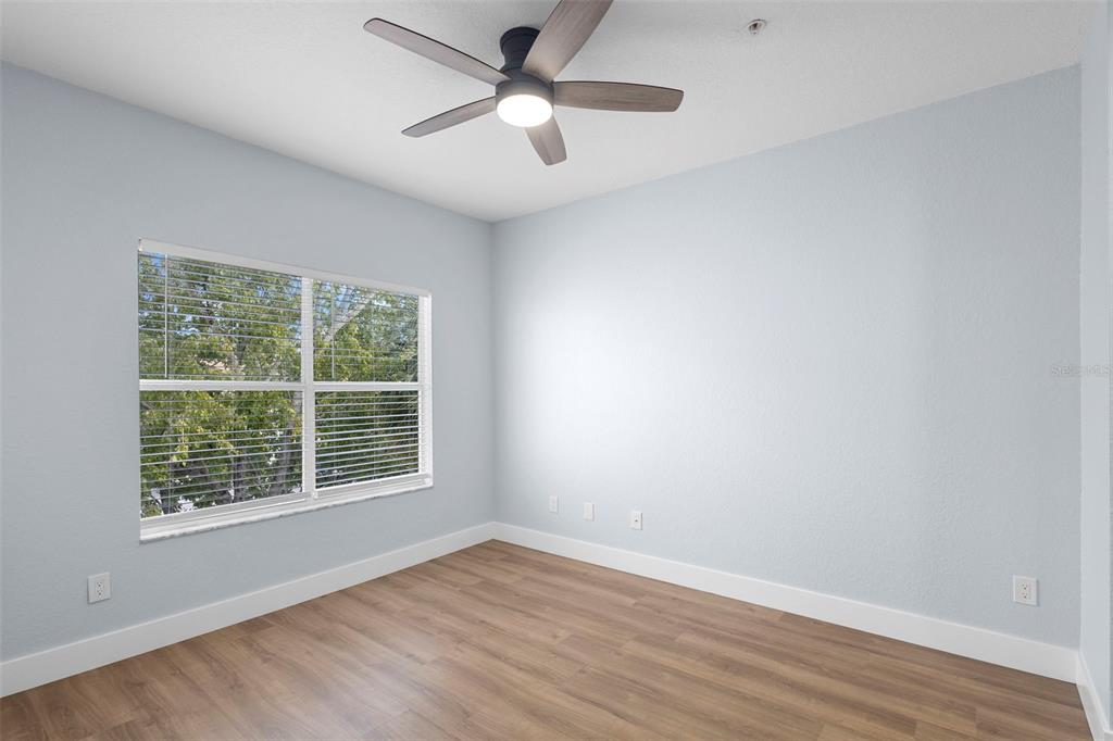 822 Camargo Way, Unit 307 Altamonte Springs, FL 32714 - Photo 32 of 46 an empty room with wooden floor and windows