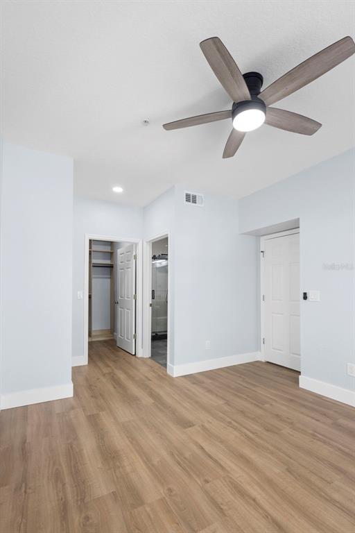 822 Camargo Way, Unit 307 Altamonte Springs, FL 32714 - Photo 35 of 46 a view of an empty room with wooden floor and a ceiling fan