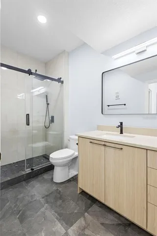 a bathroom with a double vanity sink toilet and shower