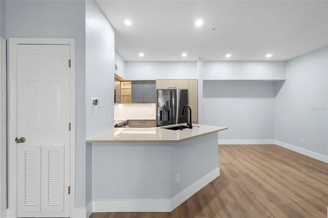 a kitchen with kitchen island a counter top space a sink and stainless steel appliances