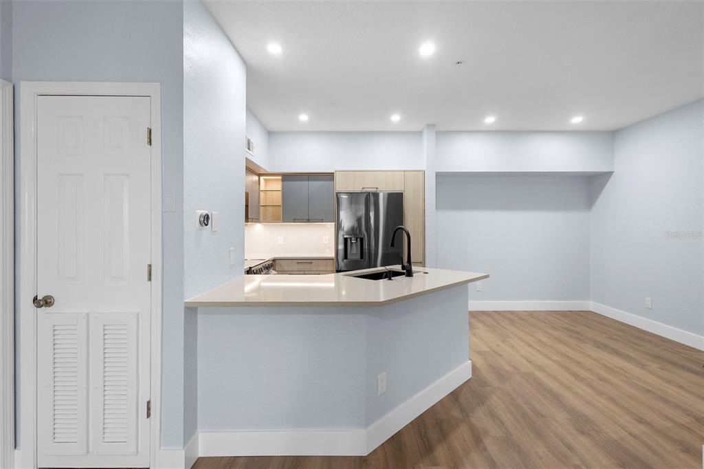 822 Camargo Way, Unit 307 Altamonte Springs, FL 32714 - Photo 43 of 46 a kitchen with kitchen island a counter top space a sink and stainless steel appliances