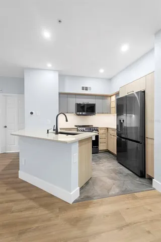a kitchen with a refrigerator sink and stove
