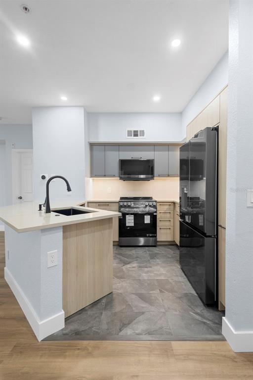 822 Camargo Way, Unit 307 Altamonte Springs, FL 32714 - Photo 45 of 46 a kitchen with stainless steel appliances granite countertop a stove a sink and a refrigerator