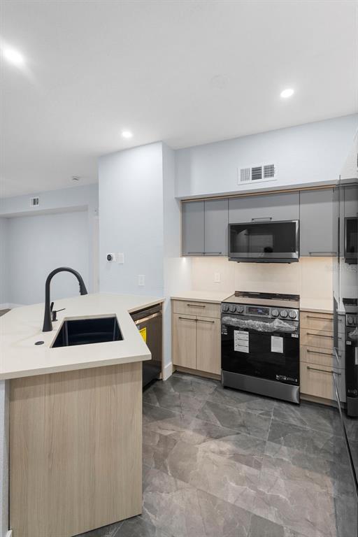 822 Camargo Way, Unit 307 Altamonte Springs, FL 32714 - Photo 10 of 46 a kitchen with stainless steel appliances a stove sink and cabinets