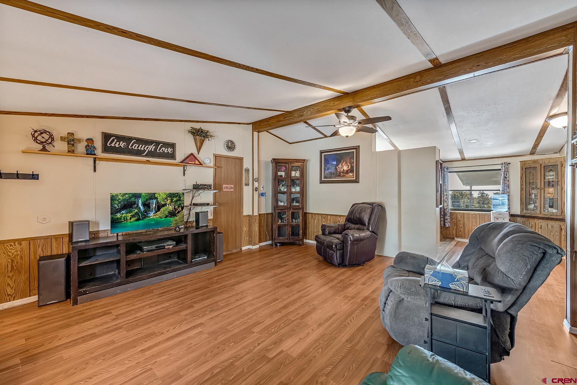 20984 Upland Road Cedaredge, CO 81413 - Photo 15 of 34 a living room with furniture and a flat screen tv