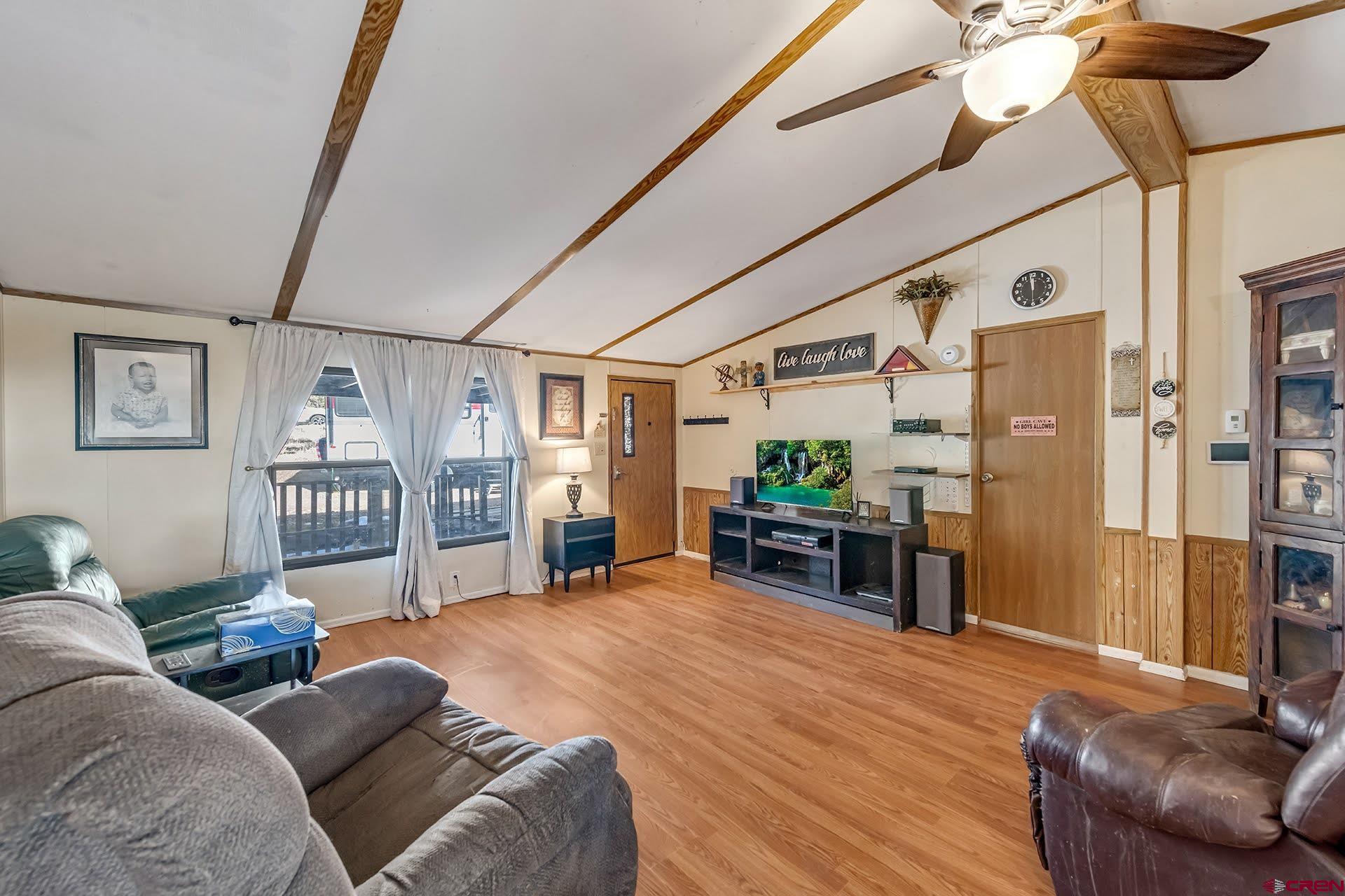 20984 Upland Road Cedaredge, CO 81413 - Photo 16 of 34 a living room with furniture and a flat screen tv