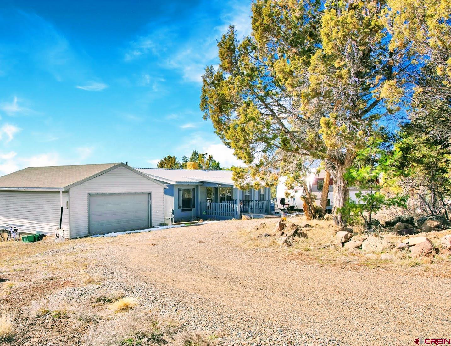 20984 Upland Road Cedaredge, CO 81413 - Photo 2 of 34 a view of a house with a yard covered in snow