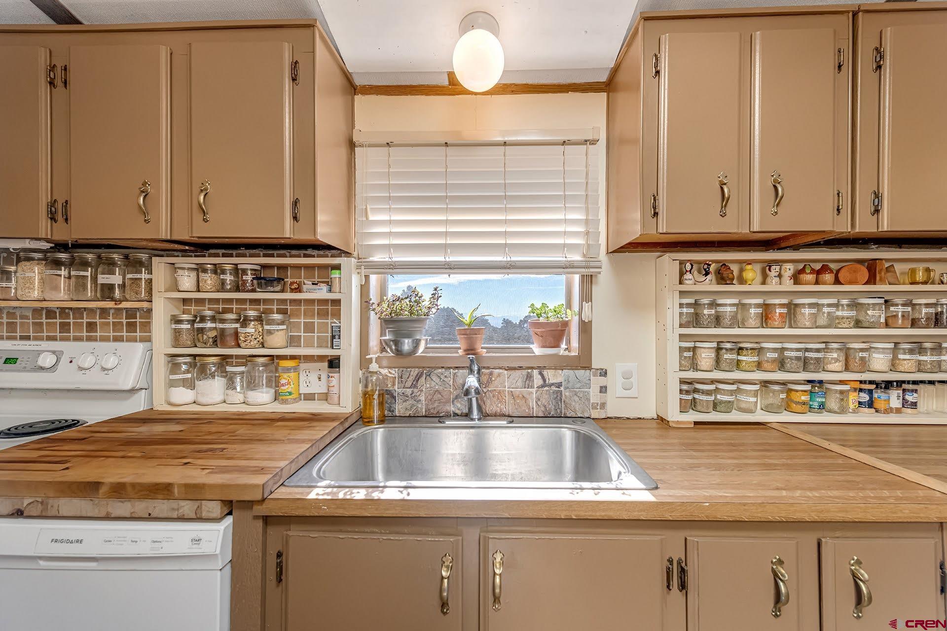 20984 Upland Road Cedaredge, CO 81413 - Photo 23 of 34 a kitchen with granite countertop a sink and a window