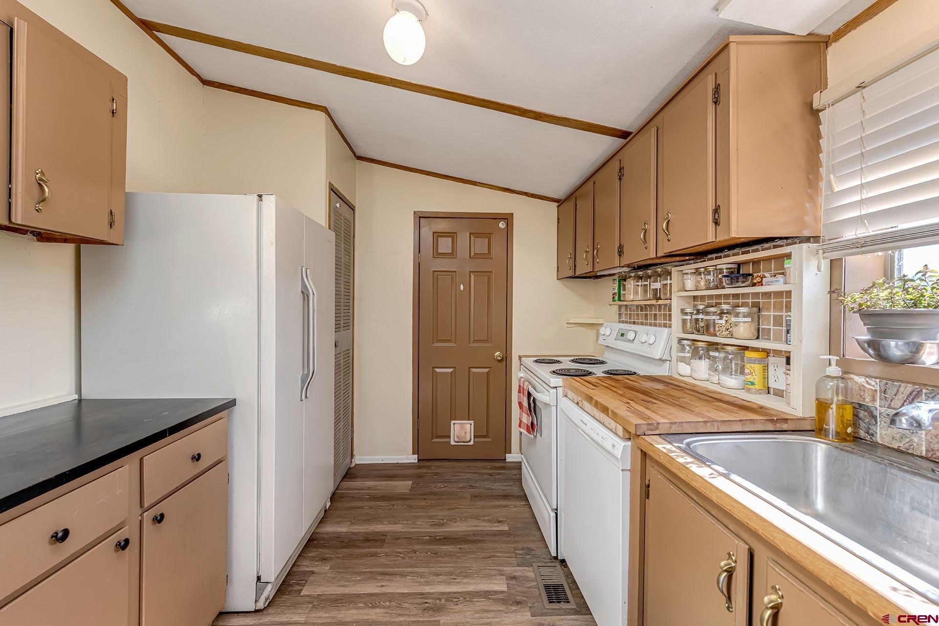 20984 Upland Road Cedaredge, CO 81413 - Photo 24 of 34 a kitchen with stainless steel appliances granite countertop a sink stove and refrigerator