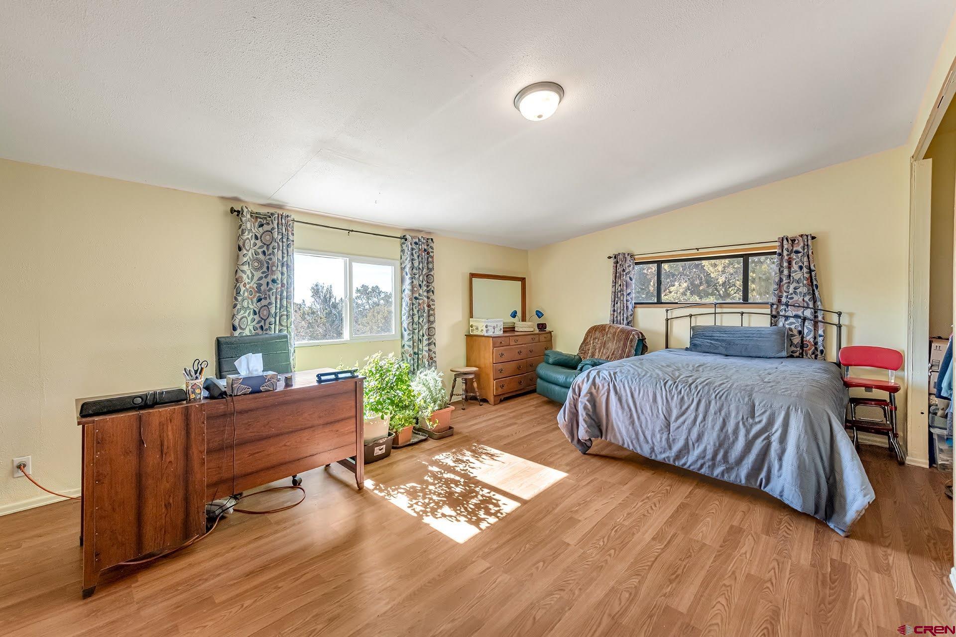 20984 Upland Road Cedaredge, CO 81413 - Photo 26 of 34 a bedroom with a bed and a table