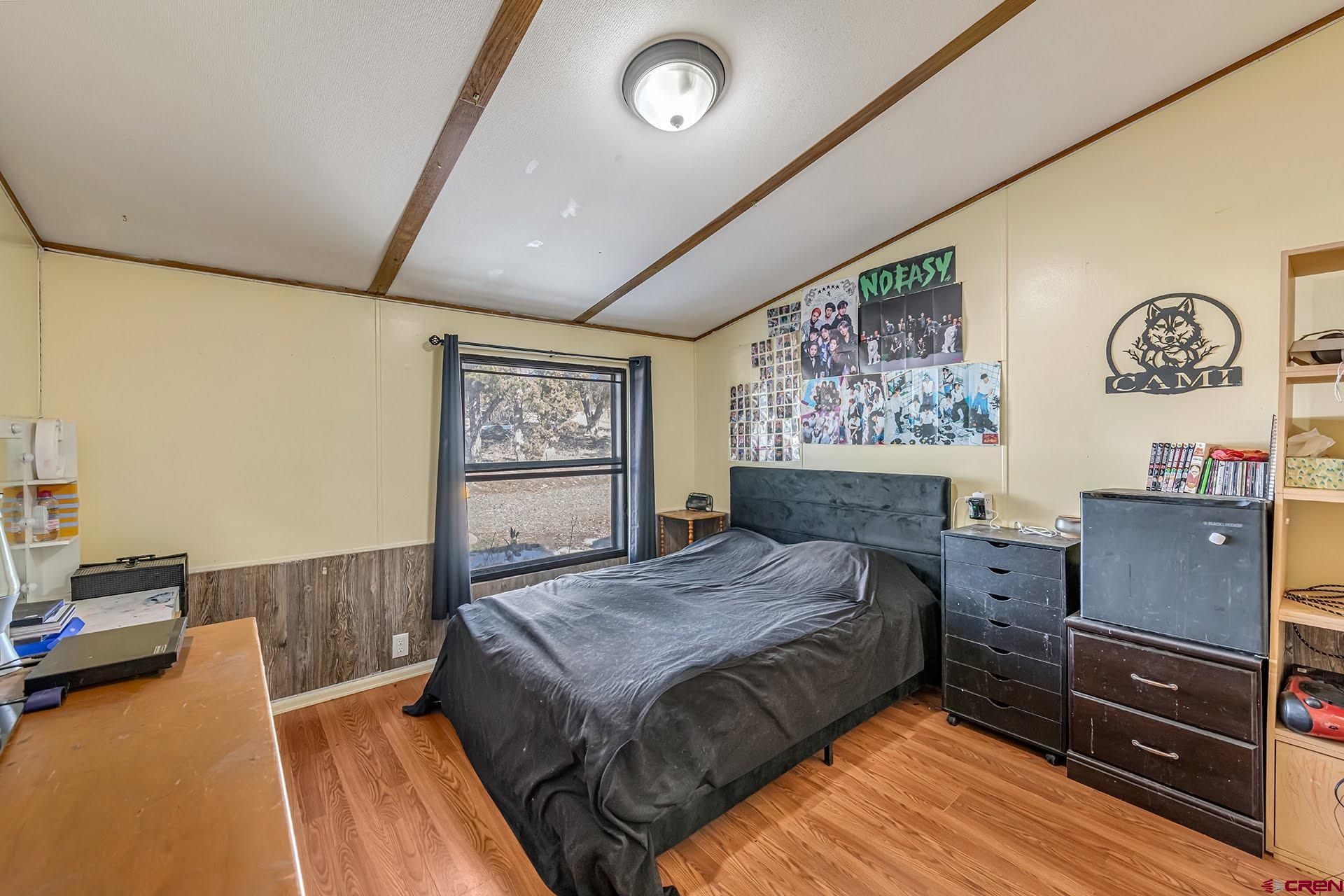 20984 Upland Road Cedaredge, CO 81413 - Photo 29 of 34 a bed room with a bed and a window