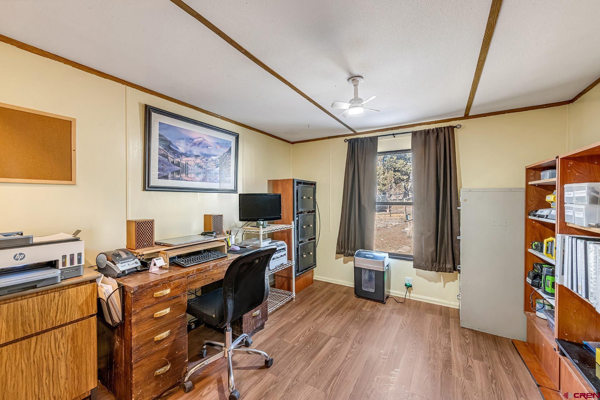 20984 Upland Road Cedaredge, CO 81413 - Photo 30 of 34 a view of a workspace with furniture and a window