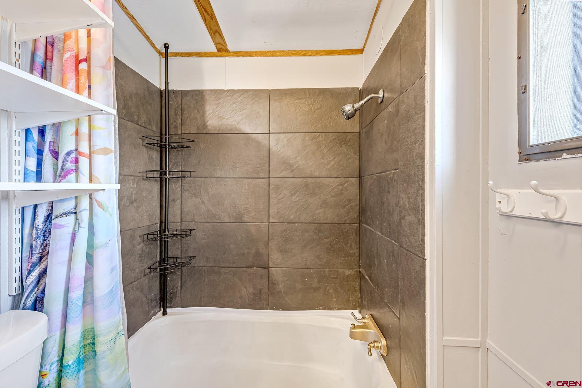 20984 Upland Road Cedaredge, CO 81413 - Photo 33 of 34 a bathroom with a bathtub and a shower