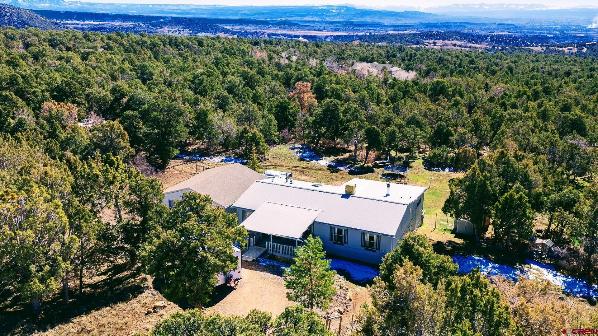 20984 Upland Road Cedaredge, CO 81413 - Photo 5 of 34 a view of a chairs and table in the backyard