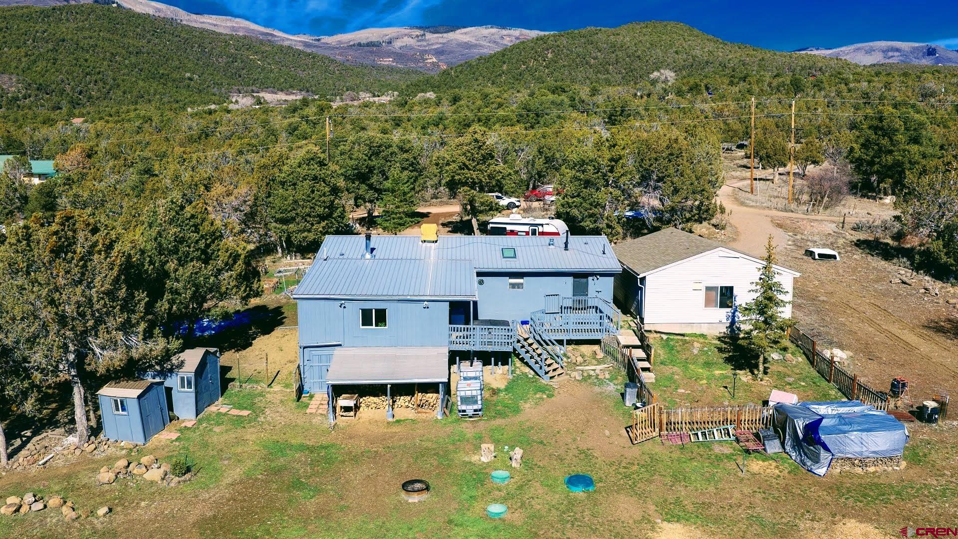 20984 Upland Road Cedaredge, CO 81413 - Photo 6 of 34 an aerial view of residential houses with outdoor space and trees