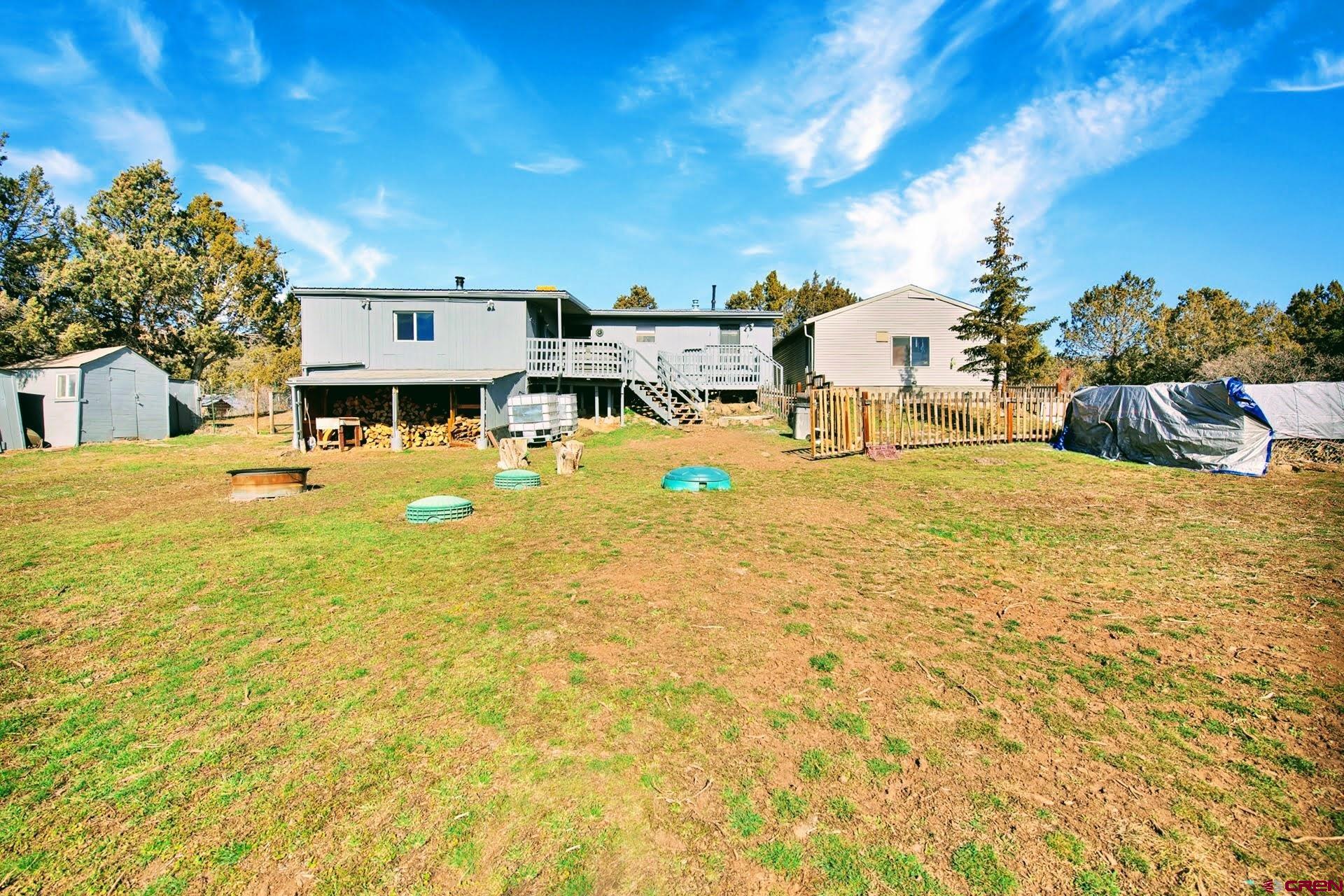 20984 Upland Road Cedaredge, CO 81413 - Photo 9 of 34 a swimming pool with outdoor seating and yard