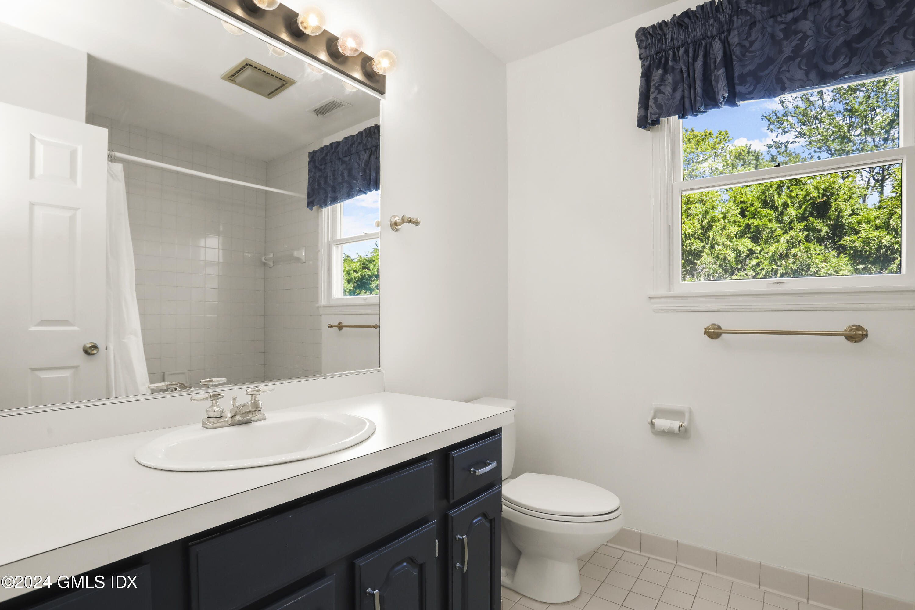 24 Sunshine Avenue Riverside, CT 06878 - Photo 11 of 20 a bathroom with a sink a toilet and a mirror