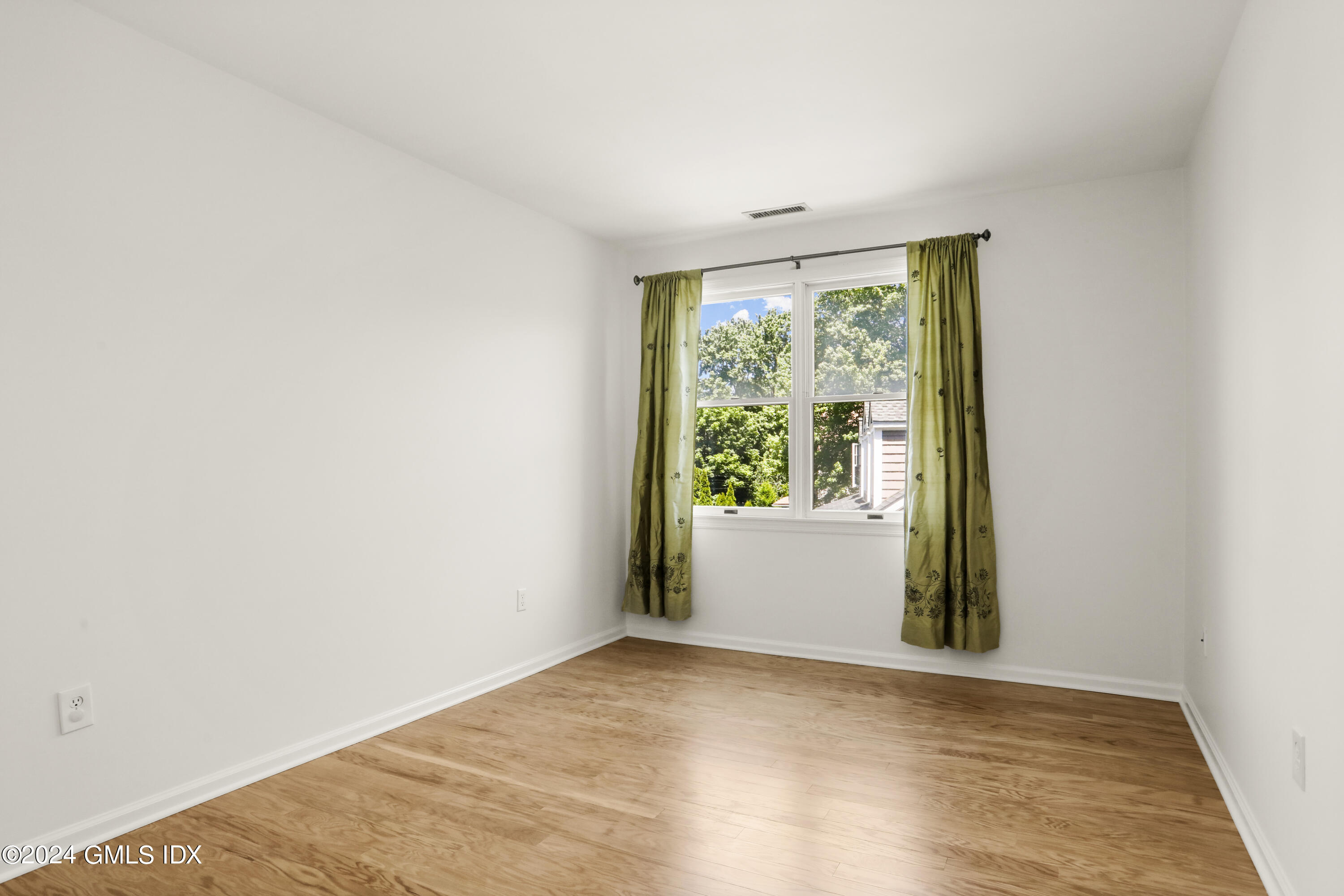 24 Sunshine Avenue Riverside, CT 06878 - Photo 14 of 20 an empty room with wooden floor and windows