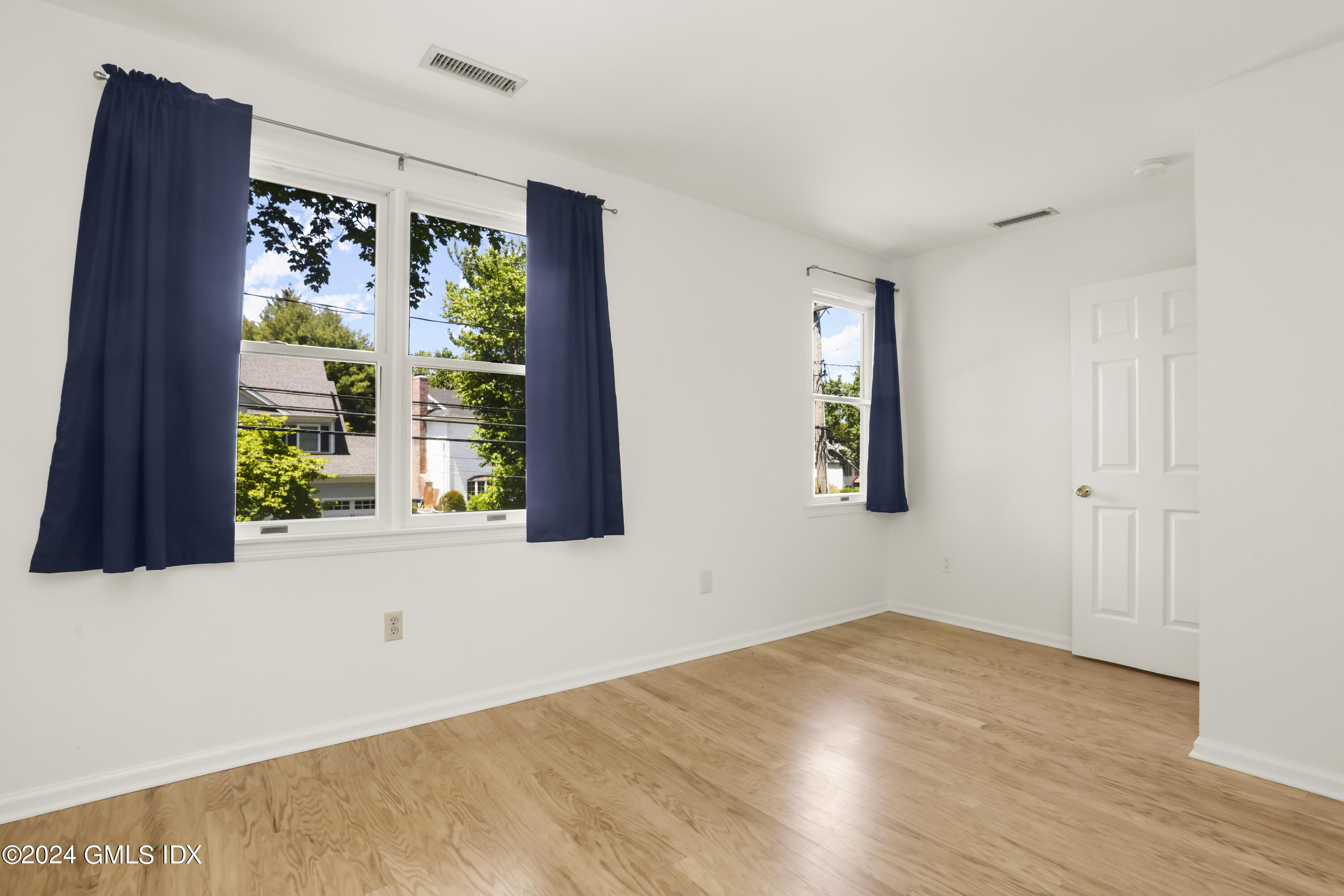 24 Sunshine Avenue Riverside, CT 06878 - Photo 16 of 20 a view of an empty room with wooden floor and a window