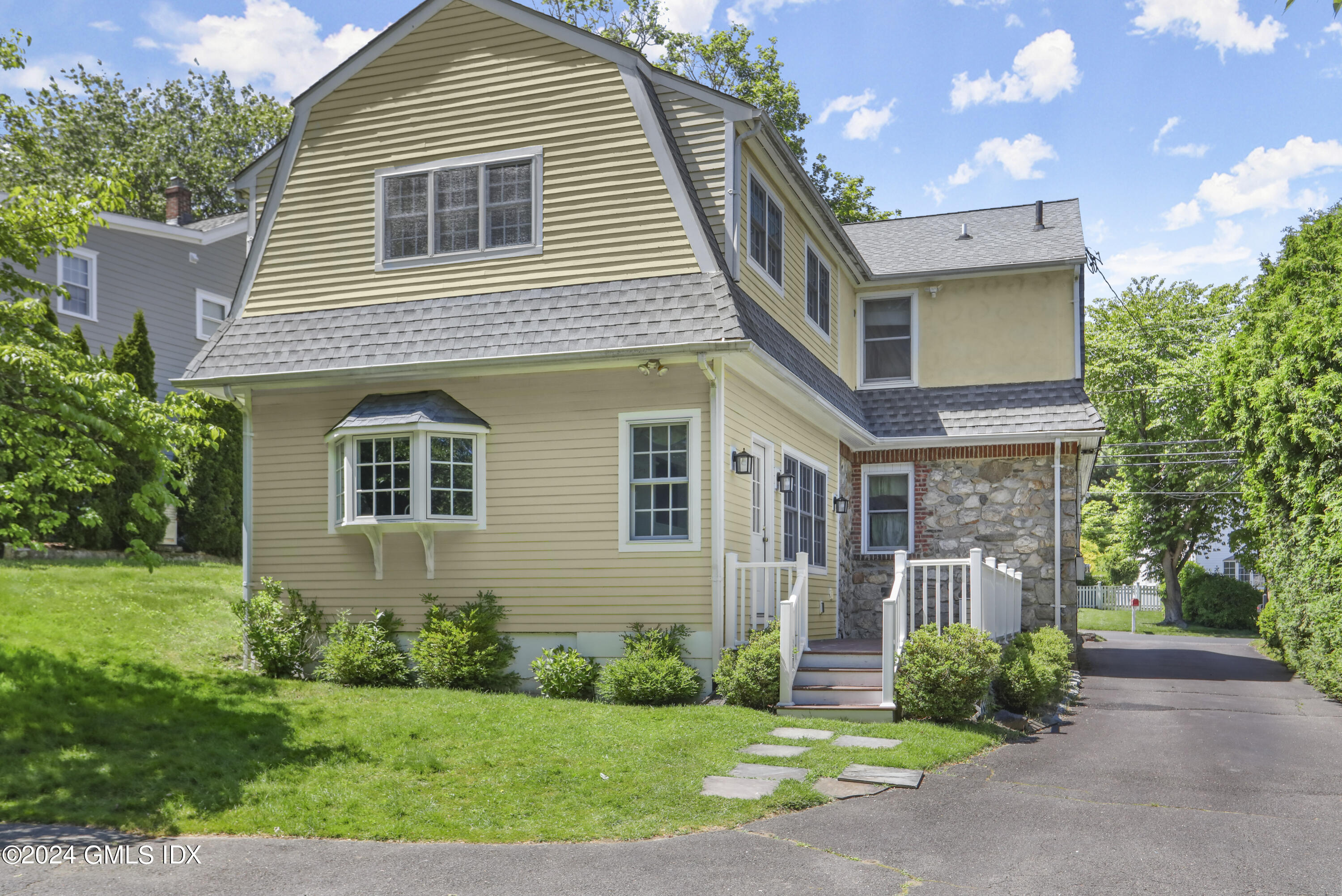 24 Sunshine Avenue Riverside, CT 06878 - Photo 2 of 20 a front view of a house with garden