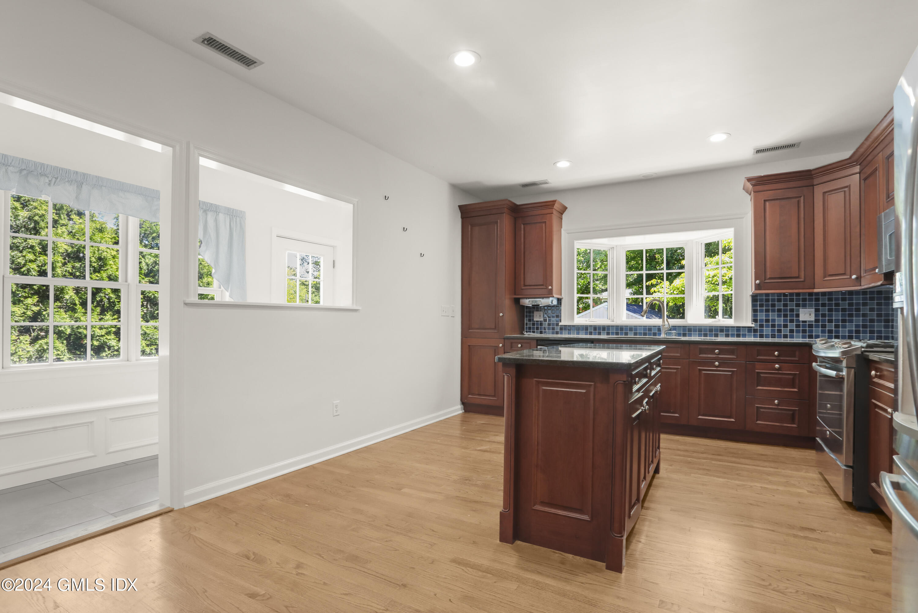 24 Sunshine Avenue Riverside, CT 06878 - Photo 4 of 20 a kitchen with stainless steel appliances granite countertop wooden cabinets a stove a sink and a window