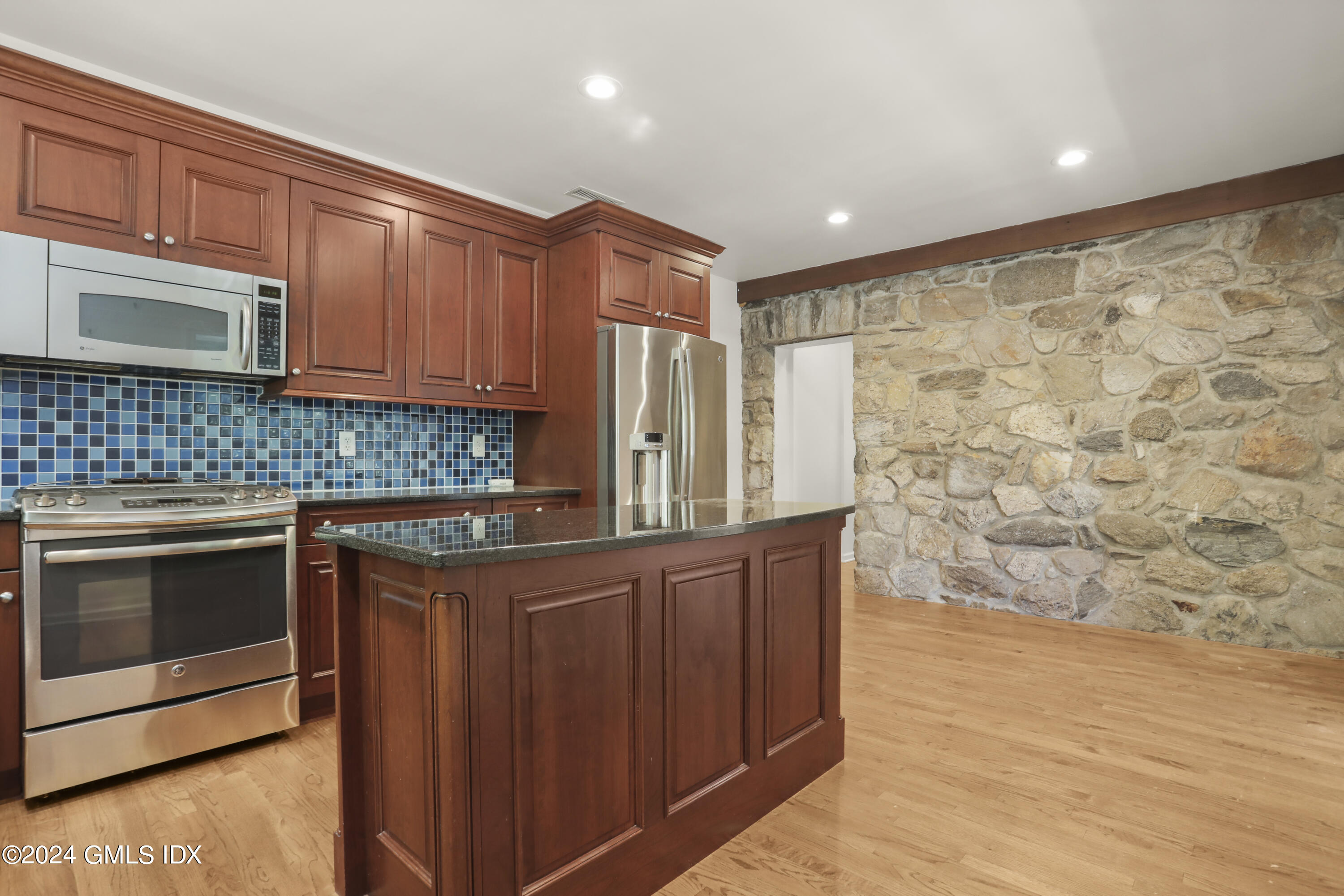 24 Sunshine Avenue Riverside, CT 06878 - Photo 5 of 20 a kitchen with stainless steel appliances granite countertop a stove a sink and a microwave