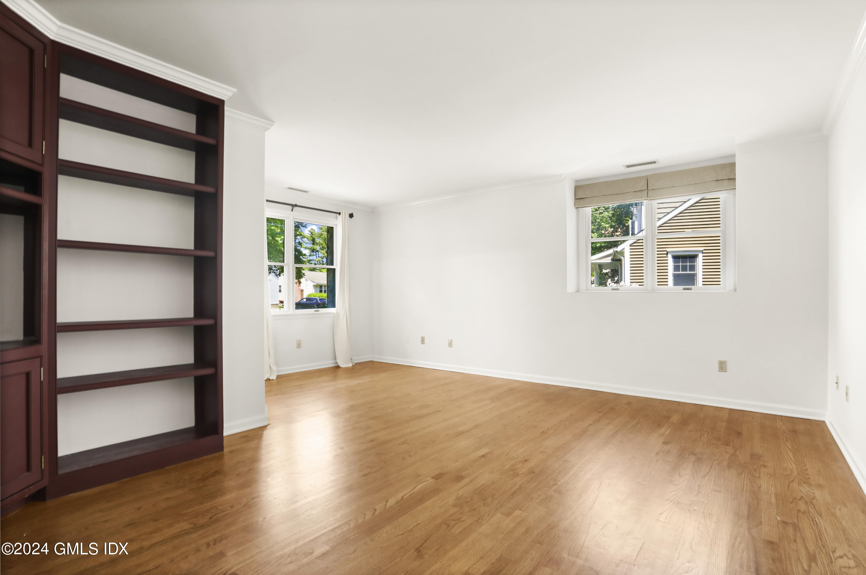 24 Sunshine Avenue Riverside, CT 06878 - Photo 6 of 20 an empty room with wooden floor closet and windows