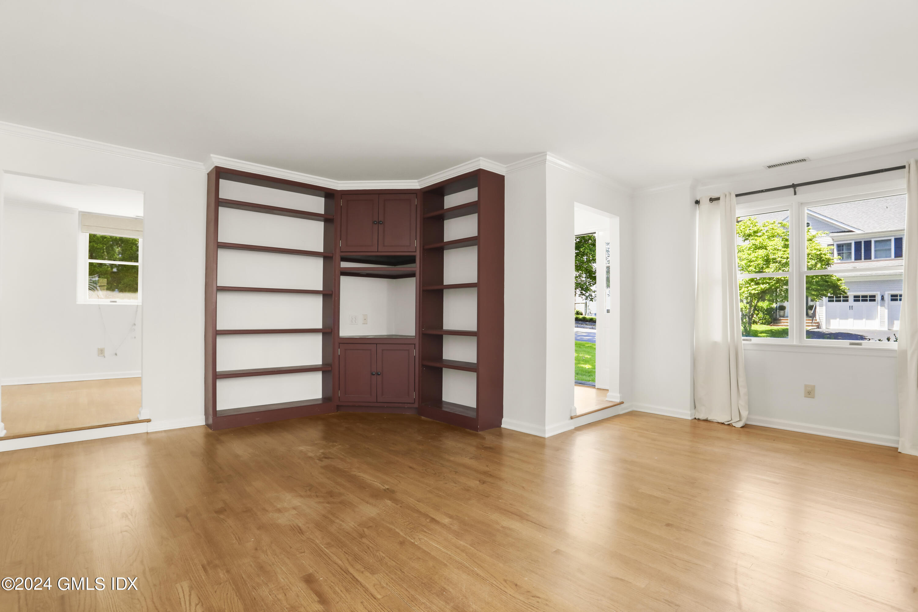 24 Sunshine Avenue Riverside, CT 06878 - Photo 7 of 20 a view of an empty room with a window and wooden floor