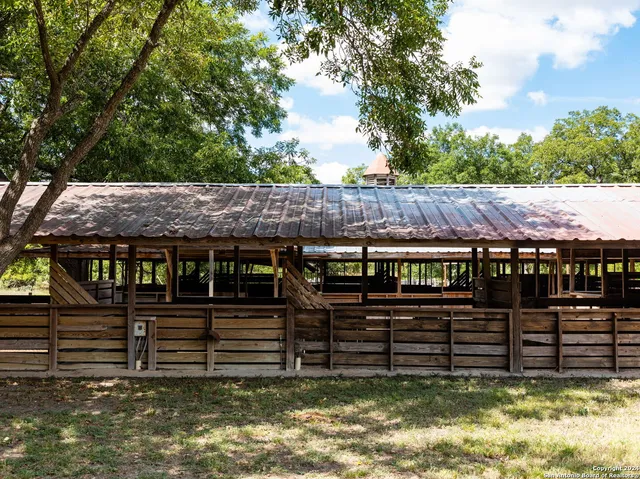 a view of a house with wooden fence