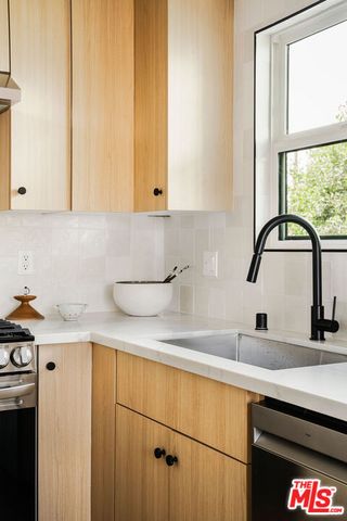 a kitchen with a sink and cabinets