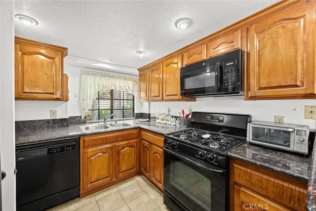 a kitchen with a sink stove top oven and microwave
