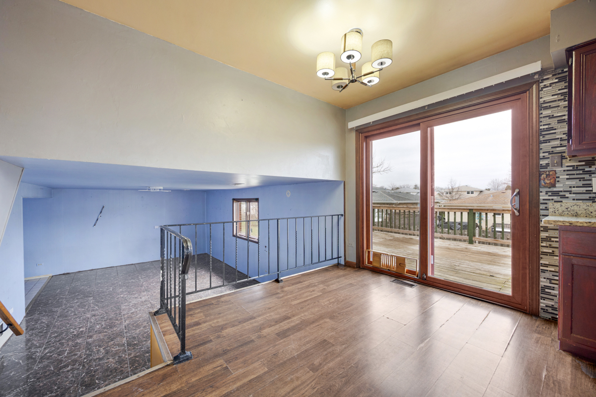 5916 West 127th Street Alsip, IL 60803 - Photo 11 of 22 a view of a livingroom with wooden floor and iron stairs