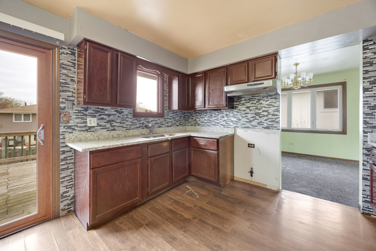 5916 West 127th Street Alsip, IL 60803 - Photo 12 of 22 a kitchen with granite countertop a sink and cabinets