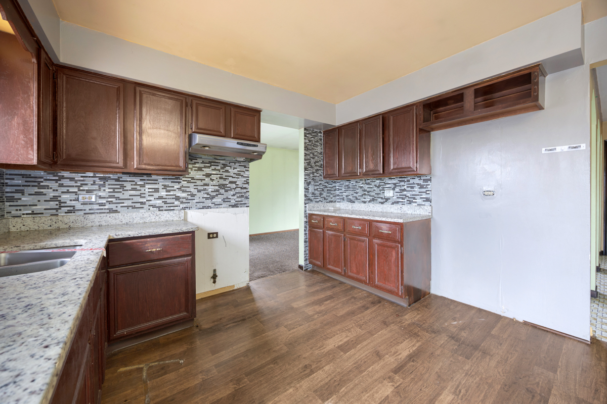 5916 West 127th Street Alsip, IL 60803 - Photo 13 of 22 a kitchen with stainless steel appliances granite countertop a stove and a refrigerator