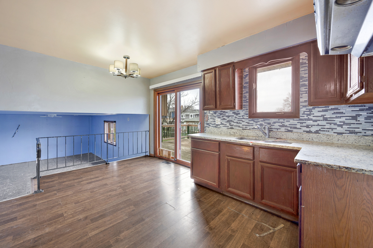 5916 West 127th Street Alsip, IL 60803 - Photo 9 of 22 a kitchen with stainless steel appliances granite countertop wooden cabinets a sink and dishwasher with wooden floor