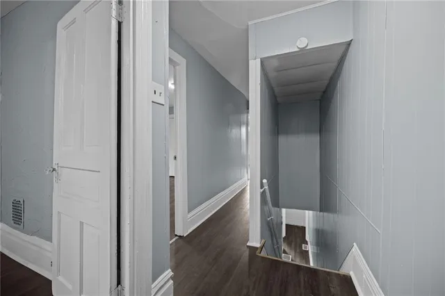 a view of hallway with wooden floor