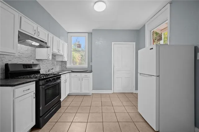 a kitchen with a stove a refrigerator and a sink