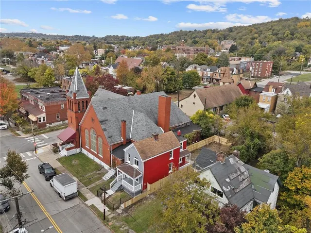 an aerial view of a house with a yard