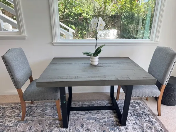 a view of a dining room with furniture and window