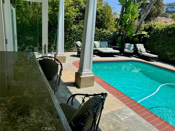 swimming pool view with a seating space