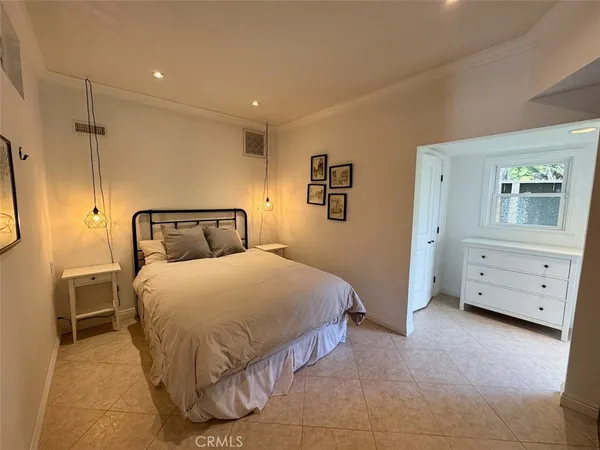 a bedroom with a bed and a night stand